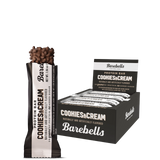 A box of Barebells protein bars in Cookies & Cream flavor, displaying the bar and packaging with branding and product information.